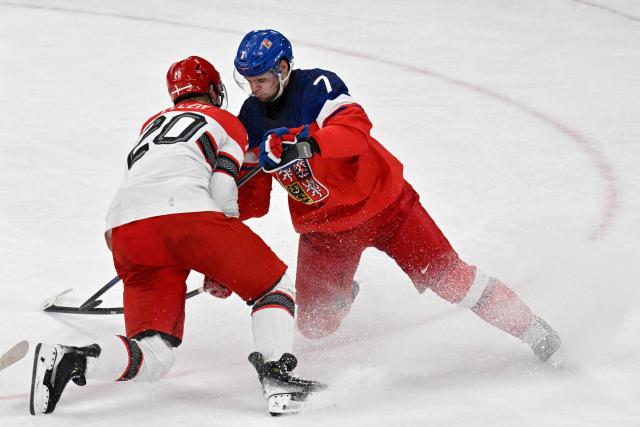 Denmark's #20 Lars Eller and Czech Republic's #07 David Spacek (R) vie for the puck during the men's qualification play-off ice hockey match between Czech Republic and Denmark at the Milano Santagiulia Ice Hockey Arena during the Milano Cortina 2026 Winter Olympic Games in Milan, on February 17, 2026. (Photo by Alexander NEMENOV / AFP)