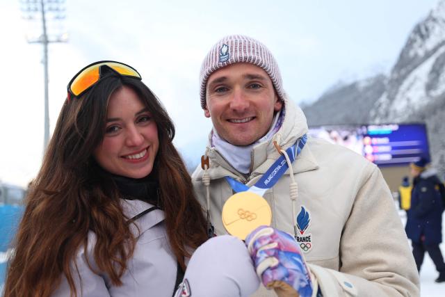 Gold medallist France's Fabien Claude celebrates with his partner after competing in the men's biathlon 4 x 7,5km relay event during the Milano Cortina 2026 Winter Olympic Games at the Anterselva Biathlon Arena (Sudtirol Arena) in Anterselva (Val Pusteria) on February 17, 2026. (Photo by FRANCK FIFE / AFP)