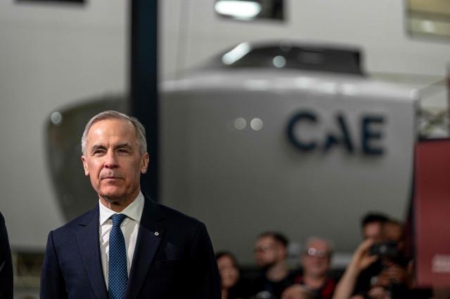 Canadian Prime Minister Mark Carney looks on peior making an announcement on new measures to strengthen security, create prosperity, and reinforce strategic autonomy at Canadian Aviation Electronics (CAE), a flight simulation company, in Montreal, Quebec, Canada, on February 17, 2026. (Photo by ANDREJ IVANOV / AFP)