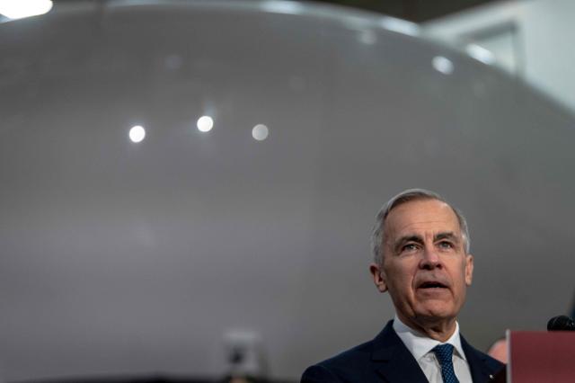 Canadian Prime Minister Mark Carney makes an announcement on new measures to strengthen security, create prosperity, and reinforce strategic autonomy at Canadian Aviation Electronics (CAE), a flight simulation company, in Montreal, Quebec, Canada, on February 17, 2026. (Photo by ANDREJ IVANOV / AFP)