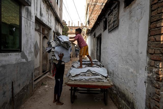 A Bangladeshi labourer carries leather at a tannery in Dhaka on February 17, 2026. (Photo by MOHD RASFAN / AFP)