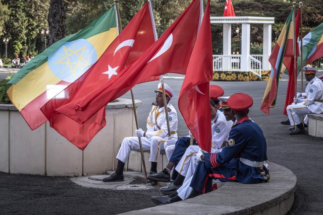 Soldiers in ceremonial uniform rest in formation holding national flags of Turkey and Ethiopia as they wait for the departure of the countries two leaders from the National Palace in Addis Ababa on February 17, 2026. (Photo by Marco Simoncelli / AFP)