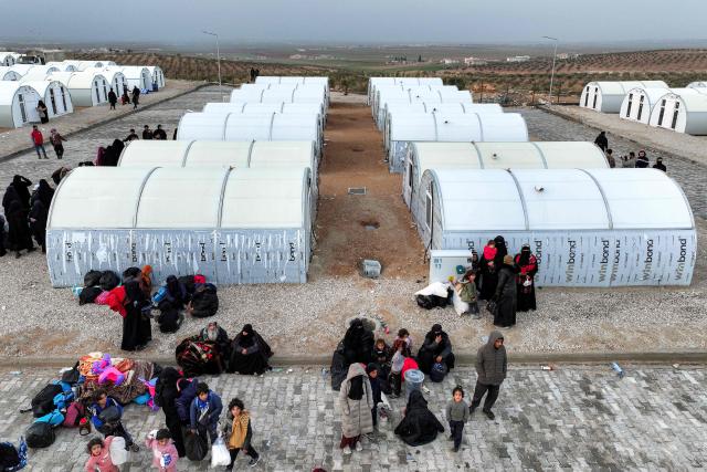This aerial view shows tent shelters for people arriving from the Hol camp in eastern Syria, at the Akbaran camp near Akhtarin, in the north of Aleppo province, on February 17, 2026. Syria began evacuating remaining residents of Al-Hol camp, which long housed relatives of suspected Islamic State group fighters, as it empties the formerly Kurdish-controlled facility, two officials told AFP. Al-Hol had been Syria's largest camp housing relatives of suspected IS fighters before it was taken over by government forces from its Kurdish administrators. (Photo by OMAR HAJ KADOUR / AFP)