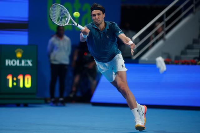 France's Arthur Rinderknech hits a return against Spain’s Carlos Alcaraz during their men’s singles match at the Qatar Open tennis tournament in Doha on February 17, 2026. (Photo by Karim JAAFAR / AFP)