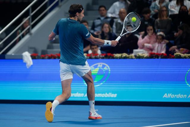 France's Arthur Rinderknech hits a return against Spain’s Carlos Alcaraz during their men’s singles match at the Qatar Open tennis tournament in Doha on February 17, 2026. (Photo by Karim JAAFAR / AFP)