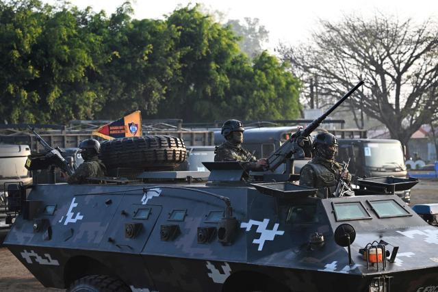 Guatemalan soldiers stand guard in an armored vehicle during the inauguration of the Sentinel Plan which seeks to provide security in the metropolitan area to curb extortion and assaults and neutralize gang operations, in the Alamedas neighbourhood in Guatemala City on February 17, 2026, (Photo by JOHAN ORDONEZ / AFP)