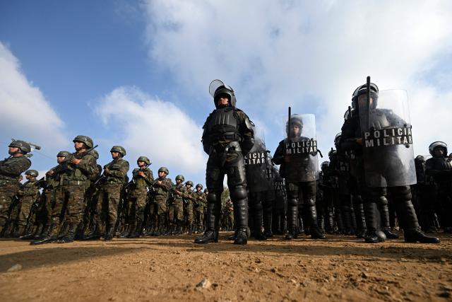 Guatemalan soldiers and police officers stand in formation during the inauguration of the Sentinel Plan which seeks to provide security in the metropolitan area to curb extortion and assaults and neutralize gang operations, in the Alamedas neighborhood in Guatemala City on February 17, 2026, (Photo by JOHAN ORDONEZ / AFP)