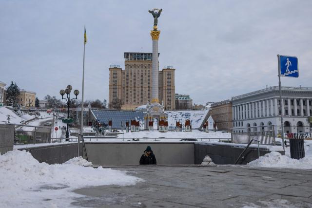 A person emerges from a subway entrance at Independence Square in central Kyiv on February 17, 2026, amid the Russian invasion of Ukraine. (Photo by HENRY NICHOLLS / AFP)