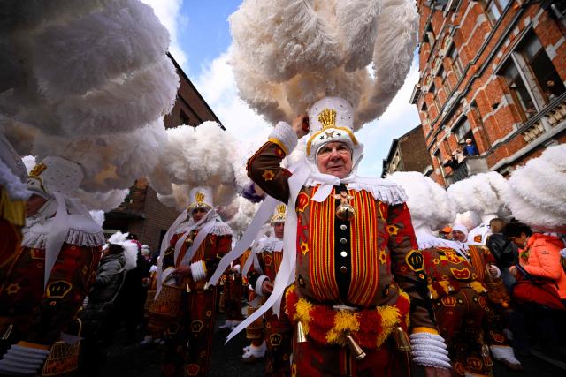 Carnival goers dressed up as Gilles de Binche, the oldest and principal participants in the Carnival of Binche, parade in Binche on February 17, 2026. The Binche Carnival tradition is one of the most ancient and representative of Wallonia and inscribed in 2008 on the Representative List of the Intangible Cultural Heritage of Humanity by UNESCO. (Photo by JOHN THYS / AFP)