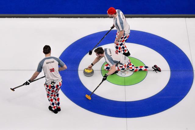 Norway's Gaute Nepstad, Norway's Bendik Ramsfjell and Norway's Martin Sesaker compete in the curling men's round robin between Sweden and Norway during the Milano Cortina 2026 Winter Olympic Games at the Cortina Curling Olympic Stadium in Cortina d’Ampezzo on February 17, 2026. (Photo by Tiziana FABI / AFP)