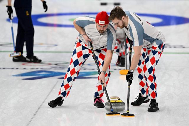 Norway's Martin Sesaker and Norway's Bendik Ramsfjell compete in the curling men's round robin between Sweden and Norway during the Milano Cortina 2026 Winter Olympic Games at the Cortina Curling Olympic Stadium in Cortina d’Ampezzo on February 17, 2026. (Photo by Tiziana FABI / AFP)