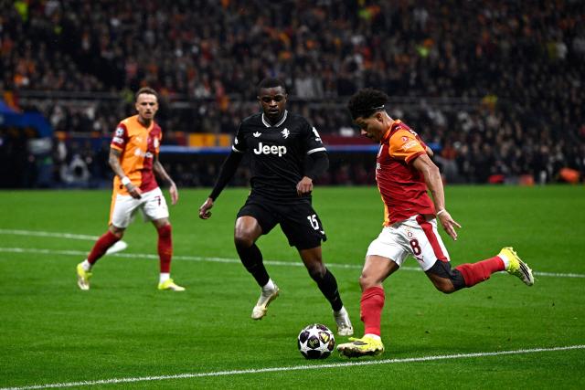Galatasaray's Brazilian midfielder #08 Gabriel Gomes Sara kicks the ball next to Juventus' French defender #15 Pierre Kalulu Kyatengwa during the UEFA Champions League, knockout round play-off 1st leg, football match between Galatasaray SK and Juventus FC at the Rams Park in Istanbul on February 17, 2026. (Photo by YASIN AKGUL / AFP)