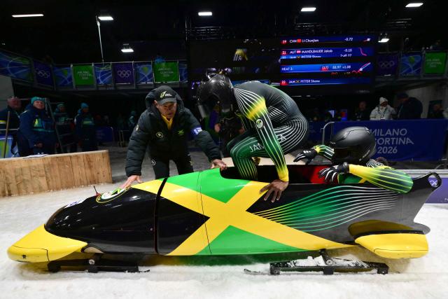 Jamaica's Shane Pitter and Jamaica's Junior Harris compete in the bobsleigh men's 2-man heat 3 at Cortina Sliding Centre during the Milano Cortina 2026 Winter Olympic Games in Cortina d'Ampezzo on February 17, 2026. (Photo by Stefano RELLANDINI / AFP)