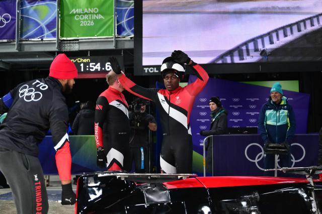 Trinidad and Tobago's Axel Brown and Trinidad and Tobago's De Aundre John compete in the bobsleigh men's 2-man heat 3 at Cortina Sliding Centre during the Milano Cortina 2026 Winter Olympic Games in Cortina d'Ampezzo on February 17, 2026. (Photo by Stefano RELLANDINI / AFP)
