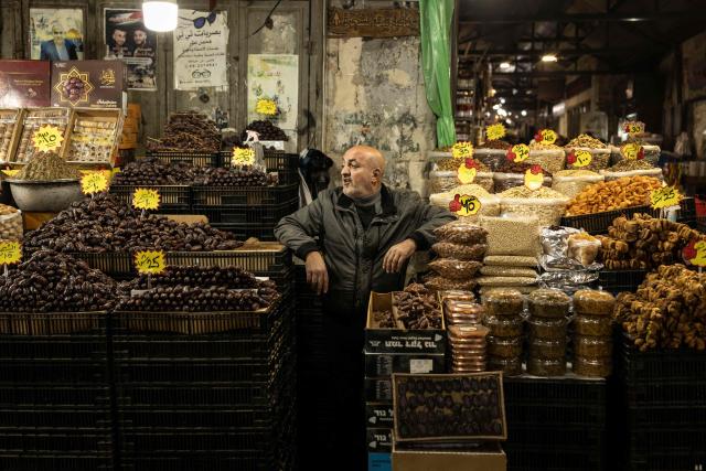 A Palestinian vendor sells dates and nuts in the old city of Nablus in the occupied West Bank on February 17, 2026, a day before the start of the Muslim holy month of Ramadan. For Muslims across the world, the beginning of the ninth month in the Muslim lunar calendar which marks the start of Ramadan, is a time for spiritual reflection, prayers, fasting and family reunions around the table after breaking the fast. (Photo by JOHN WESSELS / AFP)