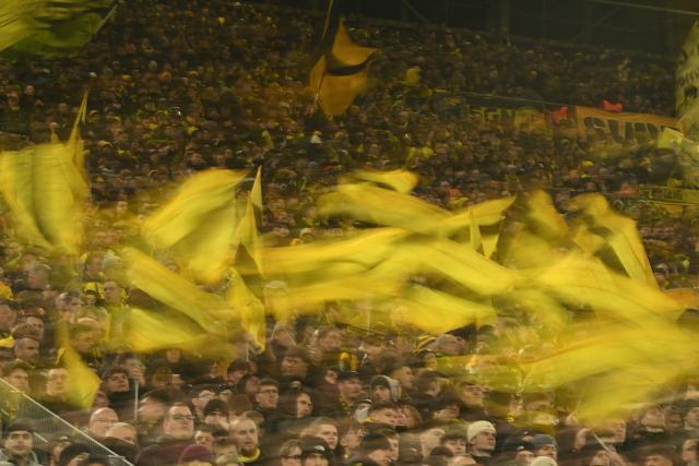 Dortmund's fans wave flags prior to the UEFA Champions League knockout round play-off first Leg football match between BVB Borussia Dortmund and Atalanta Bergamo in Dortmund, western Germany, on February 17, 2026. (Photo by INA FASSBENDER / AFP)