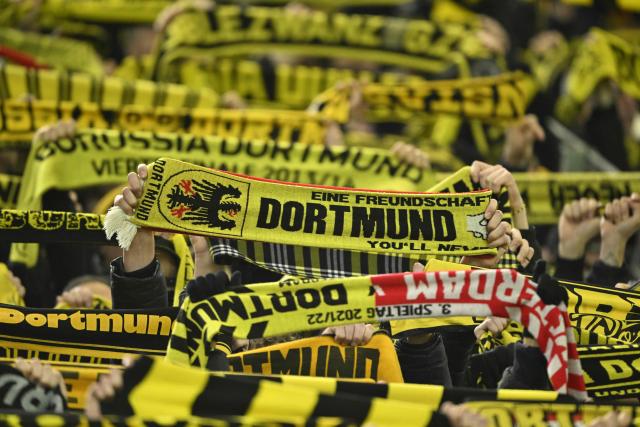 Dortmund's fans wave scarves prior to the UEFA Champions League knockout round play-off first Leg football match between BVB Borussia Dortmund and Atalanta Bergamo in Dortmund, western Germany, on February 17, 2026. (Photo by INA FASSBENDER / AFP)
