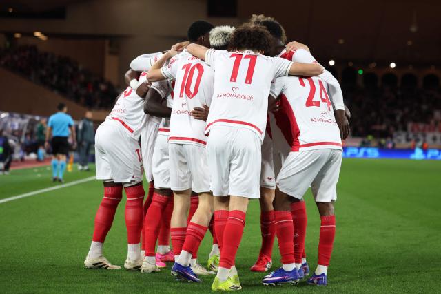 Monaco's players celebrate Monaco's US forward #09 Folarin Balogun first goal during the UEFA Champions League knockout round play-off first leg football match between AS Monaco and Paris Saint-Germain at the Stade Louis II in the Principality of Monaco on February 17, 2026. (Photo by Valery HACHE / AFP)