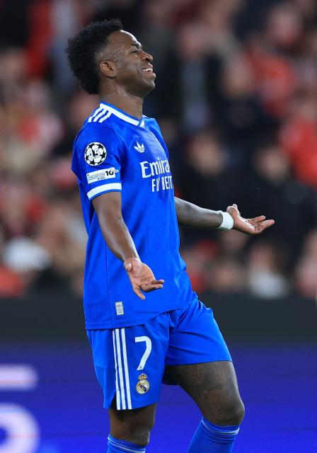 Real Madrid's Brazilian forward #07 Vinicius Junior reacts after missing a goal opportunity during the UEFA Champions League knockout round play-off first leg football match between SL Benfica and Real Madrid CF at Estadio da Luz in Lisbon on February 17, 2026. (Photo by PATRICIA DE MELO MOREIRA / AFP)