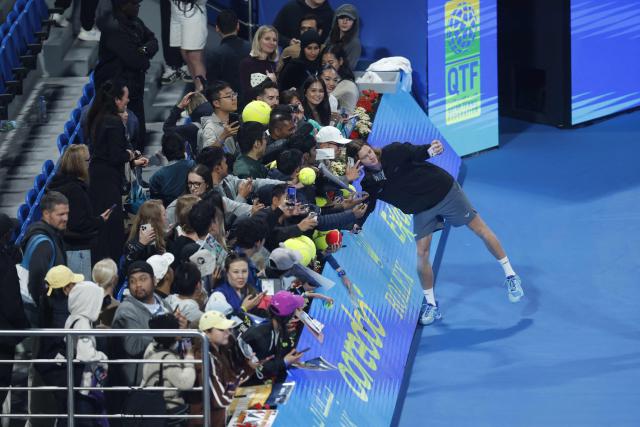 TOPSHOT - Russia's Andrey Rublev takes a picture with fans after winning against Netherlands’ Jesper De Jong during their men’s singles match at the Qatar Open tennis tournament in Doha on February 17, 2026. (Photo by Karim JAAFAR / AFP)