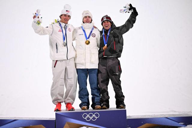 (From L) Silver medallist USA's Mac Forehand, gold medallist Norway's Tormod Frostad and bronze medallist Austria's Matej Svancer celebrate on the podium after the freestyle skiing men's freeski big air final during the Milano Cortina 2026 Winter Olympic Games at Livigno Snow Park, in Livigno (Valtellina), on February 17, 2026. (Photo by Kirill KUDRYAVTSEV / AFP)