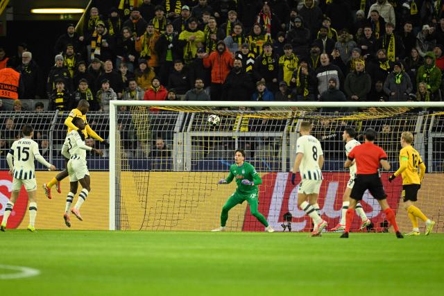 Dortmund's Guinean forward #09 Serhou Guirassy (L) scores his team's first goal during the UEFA Champions League knockout round play-off first Leg football match between BVB Borussia Dortmund and Atalanta Bergamo in Dortmund, western Germany, on February 17, 2026. (Photo by INA FASSBENDER / AFP)