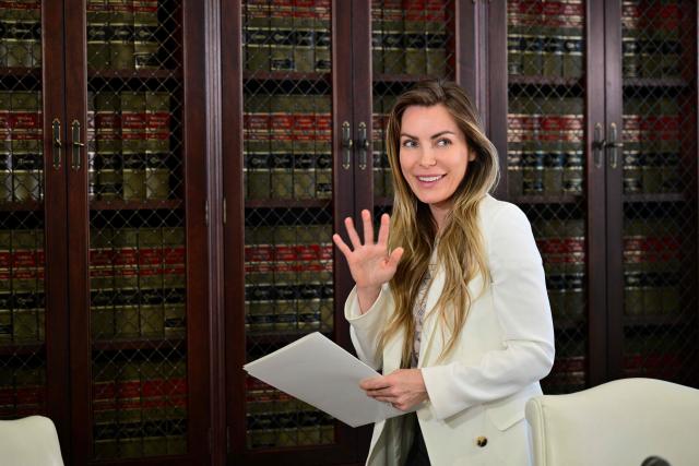 Crystal Hefner, widow of Playboy founder Hugh Hefner, waves at the end of a press conference with attorney Gloria Allred to announce steps they're taking to protect sexual images and information about women in Hefner's personal scrapbooks and diary in Los Angeles on February 17, 2026. (Photo by Frederic J. Brown / AFP)
