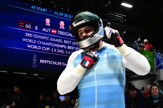 France's Romain Heinrich reacts after competing in the bobsleigh men's 2-man heat 4 at Cortina Sliding Centre during the Milano Cortina 2026 Winter Olympic Games in Cortina d'Ampezzo on February 17, 2026. (Photo by Stefano RELLANDINI / AFP)