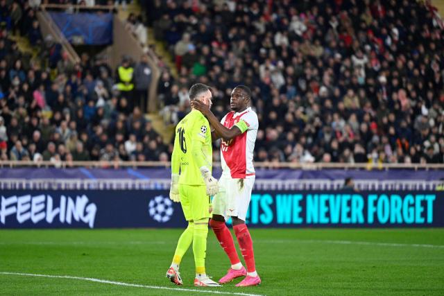 Monaco's Swiss midfielder #06 Denis Zakaria congratulates Monaco's Swiss goalkeeper #16 Philipp Kohn (L) after stopping a penalty during the UEFA Champions League knockout round play-off first leg football match between AS Monaco and Paris Saint-Germain at the Stade Louis II in the Principality of Monaco on February 17, 2026. (Photo by FREDERIC DIDES / AFP)