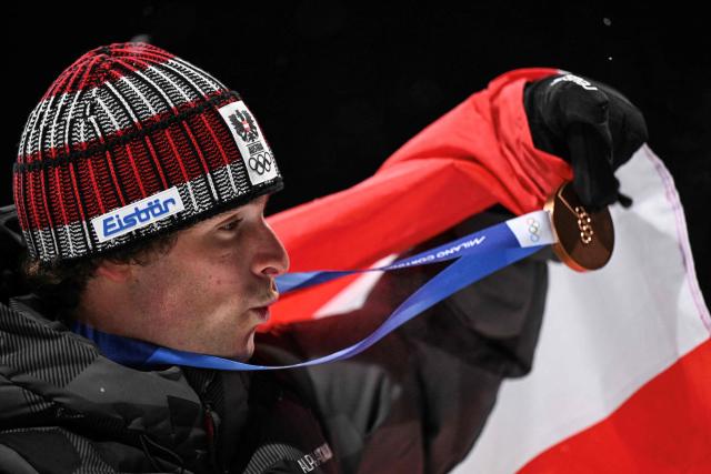Bronze medallist Austria's Matej Svancer shows his bronze medal after the freestyle skiing men's freeski big air final during the Milano Cortina 2026 Winter Olympic Games at Livigno Snow Park, in Livigno (Valtellina), on February 17, 2026. (Photo by Kirill KUDRYAVTSEV / AFP)
