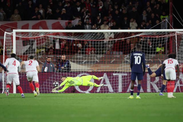 Monaco's Swiss goalkeeper #16 Philipp Kohn (C) stops a penalty during the UEFA Champions League knockout round play-off first leg football match between AS Monaco and Paris Saint-Germain at the Stade Louis II in the Principality of Monaco on February 17, 2026. (Photo by Valery HACHE / AFP)