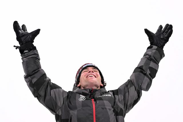 Bronze medallist Austria's Matej Svancer celebrates on the podium after the freestyle skiing men's freeski big air final during the Milano Cortina 2026 Winter Olympic Games at Livigno Snow Park, in Livigno (Valtellina), on February 17, 2026. (Photo by Kirill KUDRYAVTSEV / AFP)