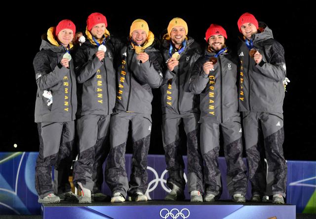 (From L) Silver medallists Germany's Francesco Friedrich and Germany's Alexander Schueller, gold medallists Germany's Johannes Lochner and Germany's Georg Fleischhauer and bronze medallists Germany's Adam Ammour and Germany's Alexander Schaller celebrate on the podium after competing in the bobsleigh men's 2-man event at Cortina Sliding Centre during the Milano Cortina 2026 Winter Olympic Games in Cortina d'Ampezzo on February 17, 2026. (Photo by Stefano RELLANDINI / AFP)