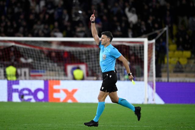 Spanish referee Jesus Gil Manzano shows a red card to Monaco's Russian midfielder #10 Aleksandr Golovin during the UEFA Champions League knockout round play-off first leg football match between AS Monaco and Paris Saint-Germain at the Stade Louis II in the Principality of Monaco on February 17, 2026. (Photo by FREDERIC DIDES / AFP)
