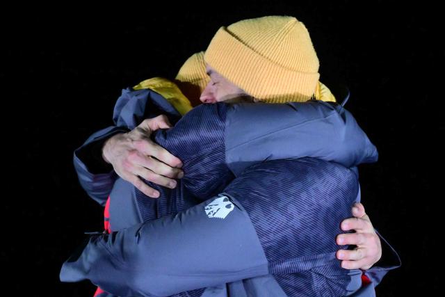 Gold medalists Germany's Johannes Lochner and Germany's Georg Fleischhauer celebrate on the podium after competing in the bobsleigh men's 2-man event at Cortina Sliding Centre during the Milano Cortina 2026 Winter Olympic Games in Cortina d'Ampezzo on February 17, 2026. (Photo by Stefano RELLANDINI / AFP)