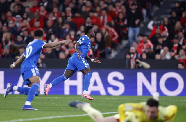 Real Madrid's Brazilian forward #07 Vinicius Junior celebrates scoring his team's first goal during the UEFA Champions League knockout round play-off first leg football match between SL Benfica and Real Madrid CF at Estadio da Luz in Lisbon on February 17, 2026. (Photo by FILIPE AMORIM / AFP)