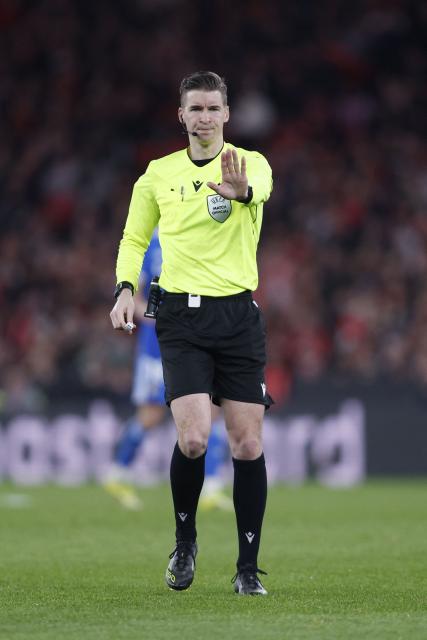 French referee Francois Letexier gestures during the UEFA Champions League knockout round play-off first leg football match between SL Benfica and Real Madrid CF at Estadio da Luz in Lisbon on February 17, 2026. (Photo by FILIPE AMORIM / AFP)