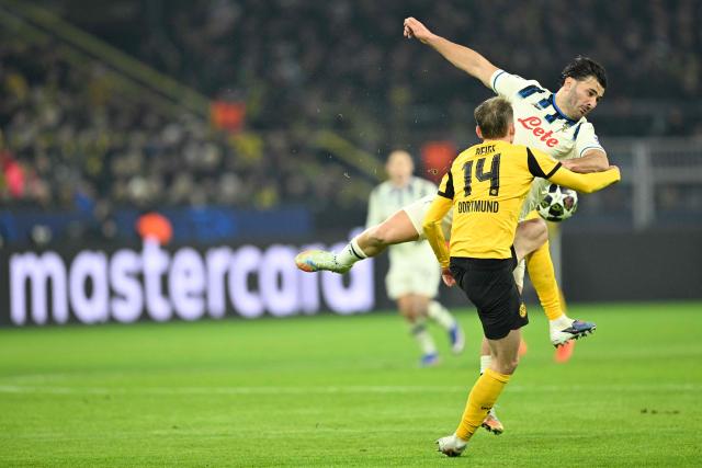 Atalanta's Bosnian defender #23 Sead Kolasinac and Dortmund's German forward #14 Maximilian Beier vie for the ball during the UEFA Champions League knockout round play-off first Leg football match between BVB Borussia Dortmund and Atalanta Bergamo in Dortmund, western Germany, on February 17, 2026. (Photo by INA FASSBENDER / AFP)