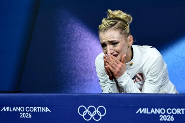 USA's Amber Glenn reacts in the kiss and cry area after competing in the figure skating women's single skating short program during the Milano Cortina 2026 Winter Olympic Games at Milano Ice Skating Arena in Milan on February 17, 2026. (Photo by WANG Zhao / AFP)