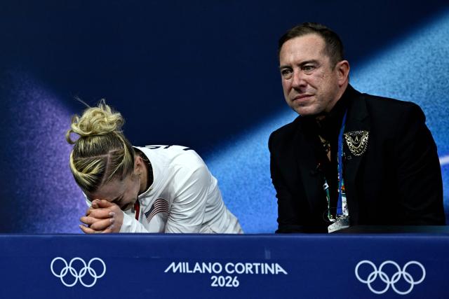 USA's Amber Glenn (L) reacts in the kiss and cry area after competing in the figure skating women's single skating short program during the Milano Cortina 2026 Winter Olympic Games at Milano Ice Skating Arena in Milan on February 17, 2026. (Photo by WANG Zhao / AFP)