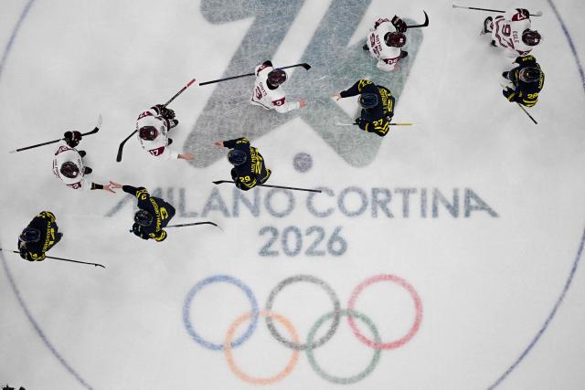 Players greet after Sweden the men's qualification play-off ice hockey match between Sweden and Latvia 5-1 at the Milano Santagiulia Ice Hockey Arena during the Milano Cortina 2026 Winter Olympic Games in Milan, on February 17, 2026. (Photo by Antonin THUILLIER / AFP)
