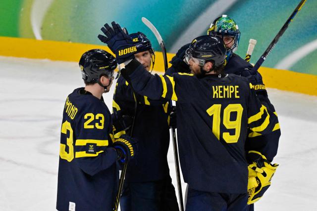 Sweden's #23 Lucas Raymond (L) and Sweden's #19 Adrian Kempe celebrate winning the men's qualification play-off ice hockey match between Sweden and Latvia at the Milano Santagiulia Ice Hockey Arena during the Milano Cortina 2026 Winter Olympic Games in Milan, on February 17, 2026. (Photo by Alexander NEMENOV / AFP)