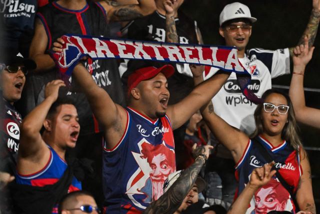 Fans of Independiente Medellin cheer for their team ahead of the Copa Libertadores phase two first-leg football match between Uruguay's Liverpool and Colombia's Independiente Medellin at the Alfredo Victor Viera Park Stadium in Montevideo on February 17, 2026. (Photo by Eitan ABRAMOVICH / AFP)