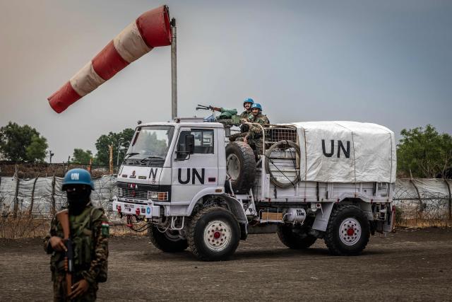 Indian peacekeepers serving with the United Nations Mission in South Sudan (UNMISS) patrol near an airstrip in the strategic opposition-controlled town of Akobo, Jonglei State on February 12, 2026. South Sudan gained independence in 2011 but quickly descended into civil war between rival generals, Salva Kiir and Riek Machar. A power-sharing deal in 2018 brought relative peace, with Kiir as president and Machar his deputy. But the deal was never fully implemented, their forces never unified, and elections never held. Over the past year, Machar has been jailed and violence has erupted between their forces in several areas. The worst has been in Jonglei state, where some 280,000 people have been displaced since December, according to the United Nations. (Photo by Luis TATO / AFP)