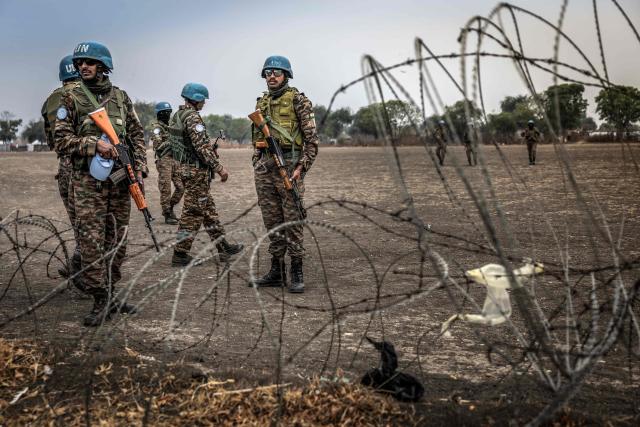 Indian peacekeepers serving with the United Nations Mission in South Sudan (UNMISS) patrol near an airstrip in the strategic opposition-controlled town of Akobo, Jonglei State, on February 12, 2026. South Sudan gained independence in 2011 but quickly descended into civil war between rival generals, Salva Kiir and Riek Machar. A power-sharing deal in 2018 brought relative peace, with Kiir as president and Machar his deputy. But the deal was never fully implemented, their forces never unified, and elections never held. Over the past year, Machar has been jailed and violence has erupted between their forces in several areas. The worst has been in Jonglei state, where some 280,000 people have been displaced since December, according to the United Nations. (Photo by Luis TATO / AFP)