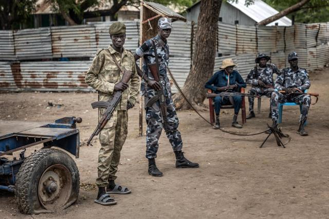 Members of the South Sudan Peoples Liberation Army in Opposition (SPLA-IO) gather at a security post outside local government offices in the strategic opposition-controlled town of Akobo, Jonglei State, on February 12, 2026. South Sudan gained independence in 2011 but quickly descended into civil war between rival generals, Salva Kiir and Riek Machar. A power-sharing deal in 2018 brought relative peace, with Kiir as president and Machar his deputy. But the deal was never fully implemented, their forces never unified, and elections never held. Over the past year, Machar has been jailed and violence has erupted between their forces in several areas. The worst has been in Jonglei state, where some 280,000 people have been displaced since December, according to the United Nations. (Photo by Luis TATO / AFP)