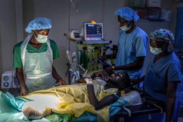 Medical workers check on a patient with an amputation following surgery for a gunshot wound sustained during clashes between the South Sudan People’s Defence Forces (SSPDF) and the South Sudan People’s Liberation Army in Opposition (SPLA-IO) in an operating theater at Akobo Teaching Hospital in the strategic opposition-controlled town of Akobo, Jonglei State, on February 12, 2026. South Sudan gained independence in 2011 but quickly descended into civil war between rival generals, Salva Kiir and Riek Machar. A power-sharing deal in 2018 brought relative peace, with Kiir as president and Machar his deputy. But the deal was never fully implemented, their forces never unified, and elections never held. Over the past year, Machar has been jailed and violence has erupted between their forces in several areas. The worst has been in Jonglei state, where some 280,000 people have been displaced since December, according to the United Nations. (Photo by Luis TATO / AFP)