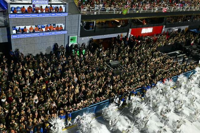 Revellers of the Paraiso do Tuiuti samba school perform in front of the jury box during the closing night of the Rio Carnival at the Marques de Sapucai Sambadrome in Rio de Janeiro, Brazil on February 17, 2026. (Photo by Pablo PORCIUNCULA / AFP)