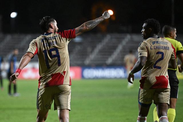Independiente Medellin's Argentine forward #19 Francisco Fydriszewski (L) celebrates next to teammate defender #02 Leyser Chaverra after scoring his team's first goal during the Copa Libertadores phase two first-leg football match between Uruguay's Liverpool and Colombia's Independiente Medellin at the Alfredo Victor Viera Park Stadium in Montevideo on February 17, 2026. (Photo by EITAN ABRAMOVICH / AFP)
