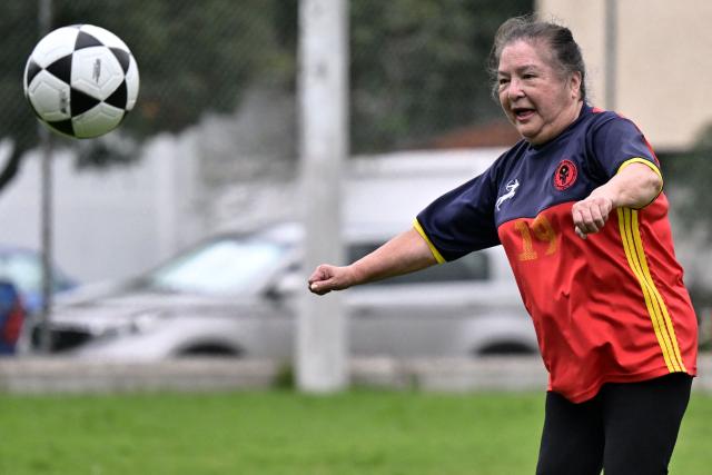 Retired teacher Angelica Aguirre, 73, eyes the ball during a training session within the Women’s Football Comprehensive Training Programme at the Catholic University in Quito on February 4, 2026. The Centre for Knowledge Transfer and Social Innovation at the Catholic University of Quito fosters a safe and inclusive space in which women can participate in the football team, regardless of their age. (Photo by Rodrigo BUENDIA / AFP)